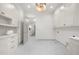 Bright laundry room featuring white cabinetry, marble countertops, and elegant marble flooring at 1084 Wrights Mill Rd, Canton, GA 30115