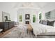 Bright main bedroom with fireplace, large windows, and a cozy seating area at 1084 Wrights Mill Rd, Canton, GA 30115