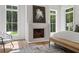 Cozy main bedroom featuring a fireplace, large windows, and a peaceful ambiance at 1084 Wrights Mill Rd, Canton, GA 30115