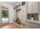 Mudroom featuring custom cabinets, bench seating, and access to the outdoor pool area at 1084 Wrights Mill Rd, Canton, GA 30115