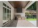 Covered patio features a built-in outdoor kitchen with grill, perfect for alfresco dining and entertaining at 1084 Wrights Mill Rd, Canton, GA 30115