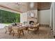 Cozy outdoor living area with a brick fireplace, wood ceiling, and views of the wooded backyard at 1084 Wrights Mill Rd, Canton, GA 30115