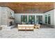 Spacious covered patio features brick flooring, an outdoor fireplace, and cozy furniture, perfect for relaxing outdoors at 1084 Wrights Mill Rd, Canton, GA 30115
