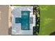 Aerial view of the modern rectangular pool with a spa, surrounded by stone pavers, grass, and lush landscaping at 1084 Wrights Mill Rd, Canton, GA 30115