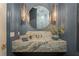 Chic powder room with marble countertop, designer lighting, and elegant mirror, adding a touch of luxury to the home at 1084 Wrights Mill Rd, Canton, GA 30115