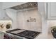 Close up of range features stainless steel appliances and custom cabinetry at 1084 Wrights Mill Rd, Canton, GA 30115