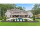 Elegant rear exterior with a luxurious pool, outdoor patio, and beautiful landscaping, ideal for entertaining at 1084 Wrights Mill Rd, Canton, GA 30115