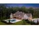 Stunning rear exterior of home with a large in-ground pool, manicured lawn, and lush landscaping at 1084 Wrights Mill Rd, Canton, GA 30115