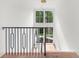 Bright staircase with modern black iron railing and light hardwood floors next to a large window at 1084 Wrights Mill Rd, Canton, GA 30115