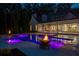 Backyard oasis featuring an in-ground pool with fire bowls and landscape lighting at dusk at 1084 Wrights Mill Rd, Canton, GA 30115
