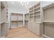Spacious walk-in closet features custom shelving, drawers, and ample hanging space for optimal organization at 1084 Wrights Mill Rd, Canton, GA 30115