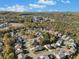 Aerial view of a vibrant community with a mix of homes nestled amidst lush, colorful trees at 308 Evening Rain Crst, Canton, GA 30114