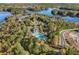 An aerial view of a community with a pool surrounded by fall trees and bordering a lake at 308 Evening Rain Crst, Canton, GA 30114