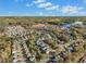 Aerial view of neighborhood with homes, lake, and trees in autumn with distant mountains at 308 Evening Rain Crst, Canton, GA 30114