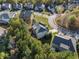 An aerial view of a home in a neighborhood with mature trees in fall color and well-manicured lawns at 308 Evening Rain Crst, Canton, GA 30114