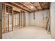 Unfinished basement, framed and ready, with lighting and exposed ceiling at 308 Evening Rain Crst, Canton, GA 30114