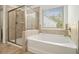 Bright bathroom featuring a soaking tub, glass shower, and natural light at 308 Evening Rain Crst, Canton, GA 30114