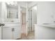 Well-lit bathroom with double vanity and doorways leading to other rooms at 308 Evening Rain Crst, Canton, GA 30114