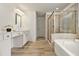 Spa-like bathroom with soaking tub, glass-enclosed shower, and vanity with ample counter space at 308 Evening Rain Crst, Canton, GA 30114