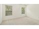Bright bedroom with neutral carpet, two windows, and a modern light fixture at 308 Evening Rain Crst, Canton, GA 30114