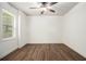 Spacious bedroom featuring hardwood floors, a ceiling fan, and a window for natural light at 308 Evening Rain Crst, Canton, GA 30114