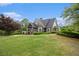 A stately home with manicured lawns and mature trees lining the property at 308 Evening Rain Crst, Canton, GA 30114