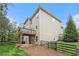 View of a well-maintained two-story home exterior with a wooden deck and fenced yard at 308 Evening Rain Crst, Canton, GA 30114
