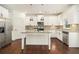 Bright kitchen with white cabinets, granite counters, stainless steel appliances, and center island at 308 Evening Rain Crst, Canton, GA 30114