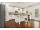 Bright kitchen featuring white cabinets, granite countertops, stainless steel appliances, and central island at 308 Evening Rain Crst, Canton, GA 30114