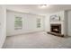 Inviting living room with a stone fireplace, bright windows, and neutral carpet at 308 Evening Rain Crst, Canton, GA 30114