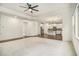 Open-concept living space with a view into the kitchen and stainless steel appliances at 308 Evening Rain Crst, Canton, GA 30114