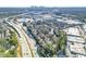 Wide aerial shot showcasing a city skyline, highway, and buildings, with dense surrounding foliage at 516 Summit North Ne Dr, Atlanta, GA 30324