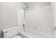 Bright bathroom featuring a bathtub with shower, white tile, and modern fixtures, providing a clean and functional space at 516 Summit North Ne Dr, Atlanta, GA 30324