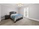 Cozy bedroom with neutral tones, including a gray bed frame, carpet, and natural light from the window at 516 Summit North Ne Dr, Atlanta, GA 30324