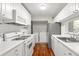 Bright kitchen features white cabinets, countertops, and appliances, with a laundry area in the background at 516 Summit North Ne Dr, Atlanta, GA 30324
