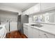Efficient kitchen with stainless-steel appliances, white cabinets, and convenient laundry area at 516 Summit North Ne Dr, Atlanta, GA 30324
