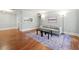 Bright living room with a gray sofa, patterned rug, and hardwood floors, adjacent to the kitchen at 516 Summit North Ne Dr, Atlanta, GA 30324