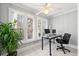 Bright sunroom with a ceiling fan, tiled floors, windows, and a workspace, perfect for remote work or relaxation at 516 Summit North Ne Dr, Atlanta, GA 30324