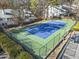 Aerial shot of community tennis court with green and blue surface, surrounded by fences and trees at 516 Summit North Ne Dr, Atlanta, GA 30324