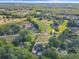 Expansive aerial view of a wooded property featuring a charming home, and horse stables nearby at 5360 Franklin Goldmine Rd, Cumming, GA 30028