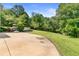A sprawling backyard offers space for a golf cart, lush greenery, and playground for endless outdoor adventures at 5360 Franklin Goldmine Rd, Cumming, GA 30028