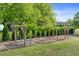A lush garden features grape vines trained along a wooden pergola, creating a charming outdoor space at 5360 Franklin Goldmine Rd, Cumming, GA 30028