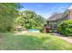 Expansive backyard with above ground pool, patio area with seating, and lush greenery at 5360 Franklin Goldmine Rd, Cumming, GA 30028