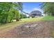 Large backyard with mature trees, grassy area, and play set offers ample space for outdoor fun at 5360 Franklin Goldmine Rd, Cumming, GA 30028