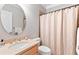 Well-lit bathroom with a vanity and shower curtain at 5360 Franklin Goldmine Rd, Cumming, GA 30028