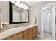 Neutral bathroom with a light wood cabinet, granite counters, and a framed mirror over the sink at 5360 Franklin Goldmine Rd, Cumming, GA 30028