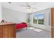 Cozy bedroom with natural light, a ceiling fan and a large window view at 5360 Franklin Goldmine Rd, Cumming, GA 30028
