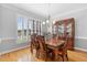 Traditional dining room features hardwood floors, plantation shutters, and an elegant chandelier at 5360 Franklin Goldmine Rd, Cumming, GA 30028