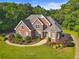 Beautiful brick home featuring manicured landscaping and a circular driveway at 5360 Franklin Goldmine Rd, Cumming, GA 30028