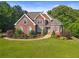 Charming brick home with a well-manicured lawn and beautiful landscaping at 5360 Franklin Goldmine Rd, Cumming, GA 30028